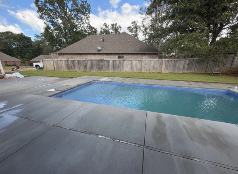 Finished fiberglass pool with surrounding decking